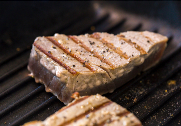 Dinko Tuna - Grill tuna Close up of chargrilled tuna steaks cooking in a griddle pan