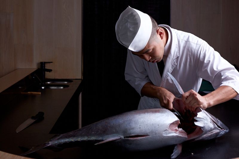 Chef slicing a whole Tuna