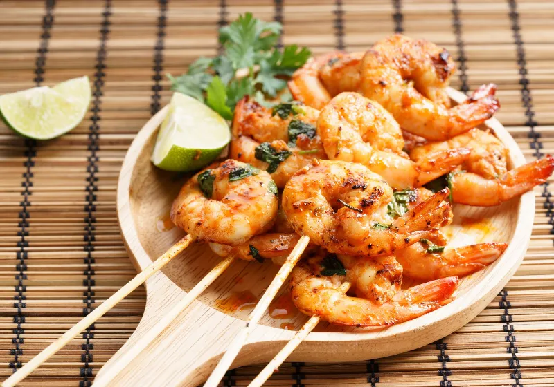 shrimp sriracha kebabs with lime and cilantro leaves