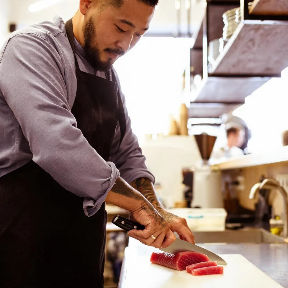 Melbourne chef prepares sashimi from Southern Bluefin Tuna Akami in restaurant kitchen.